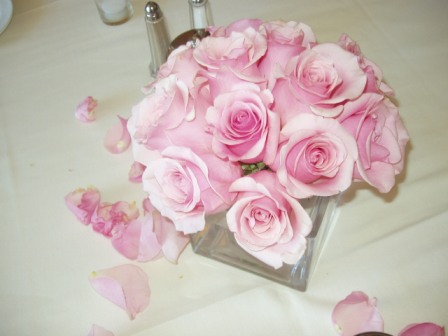 One dozen roses with filler in a glass silver or other vase